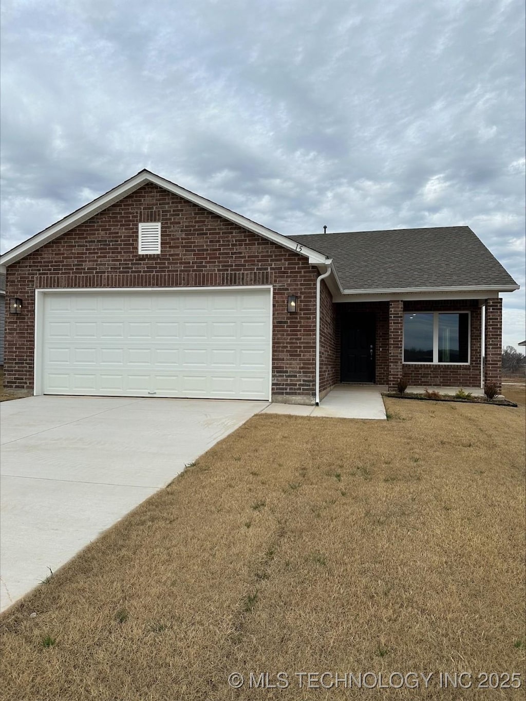 ranch-style house featuring a garage and a front yard