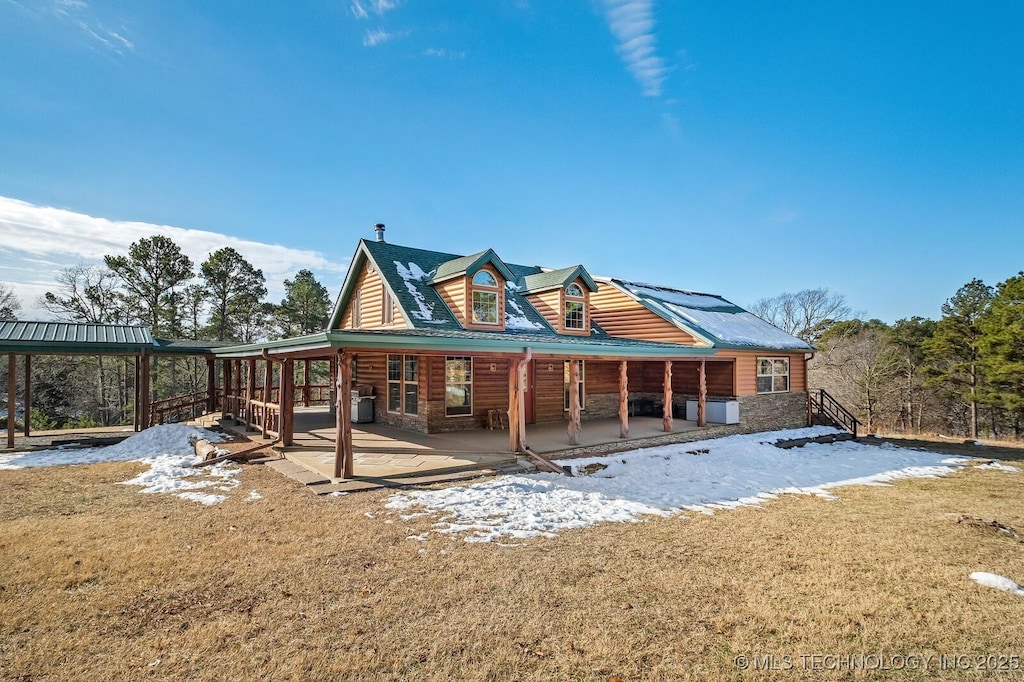 rear view of property with a lawn