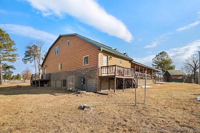 view of side of home with a wooden deck and central AC