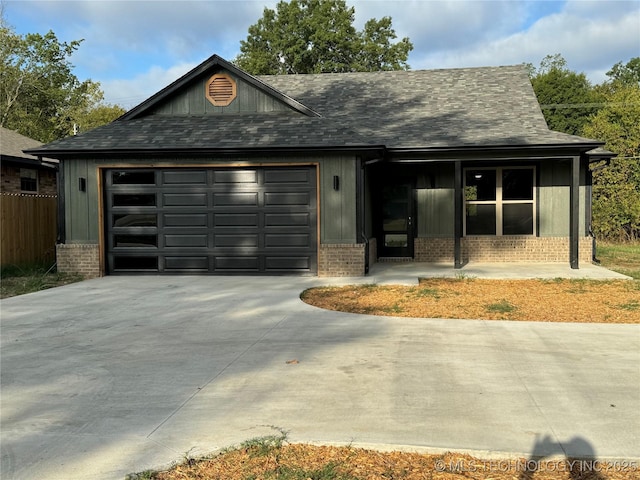 view of front of home featuring covered porch and a garage