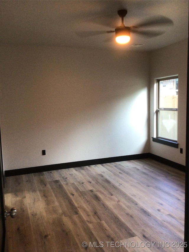 spare room with hardwood / wood-style flooring