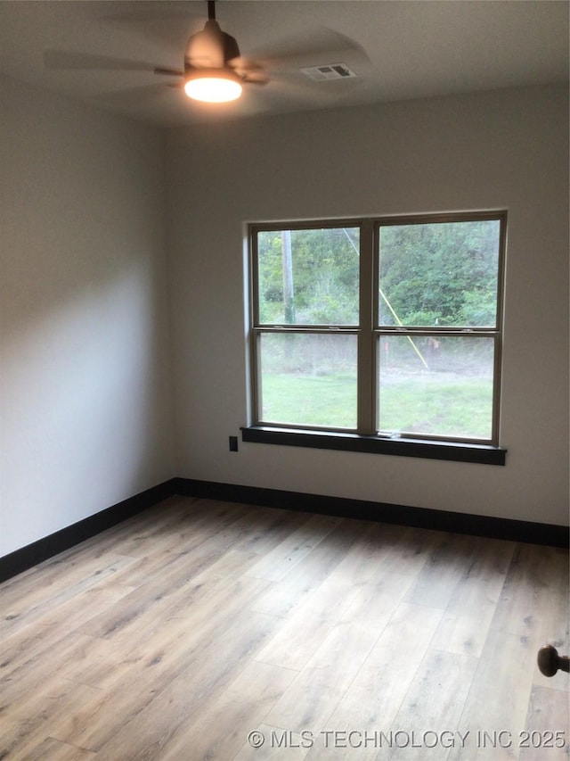 spare room with light hardwood / wood-style floors