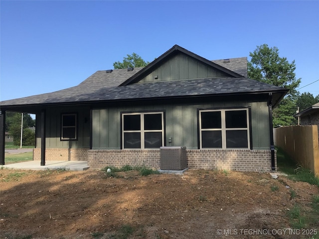 view of side of property featuring a patio and central AC