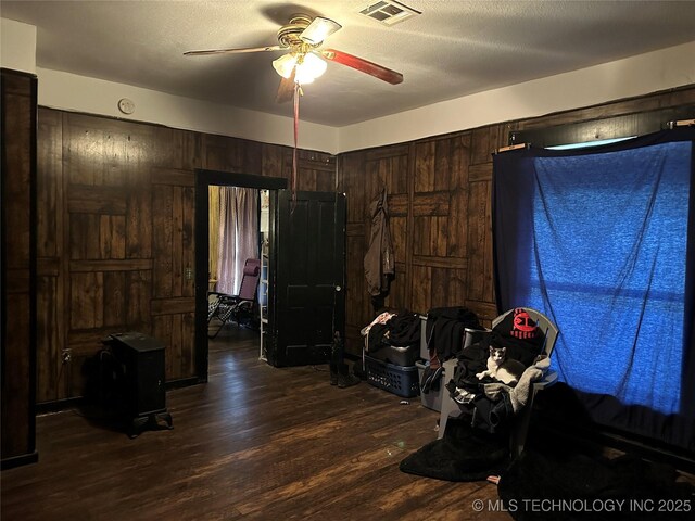 119 S Arkansas St, Caddo, OK 74729 - bedroom featuring ceiling fan, dark wood-type flooring, and visible vents