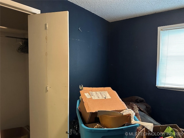 119 S Arkansas St, Caddo, OK 74729 - bedroom with multiple windows and a textured ceiling
