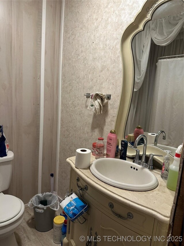 119 S Arkansas St, Caddo, OK 74729 - bathroom featuring toilet, tile patterned flooring, and vanity