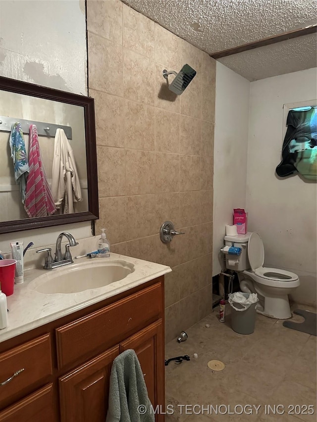 119 S Arkansas St, Caddo, OK 74729 - bathroom with toilet, vanity, a shower, and a textured ceiling