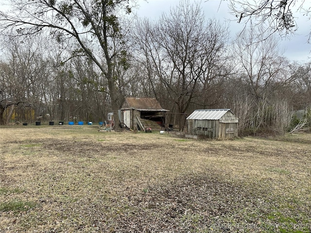 119 S Arkansas St, Caddo, OK 74729 - view of yard with an outdoor structure and a storage shed