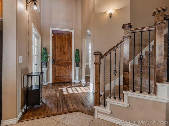 foyer with tile patterned flooring and a high ceiling