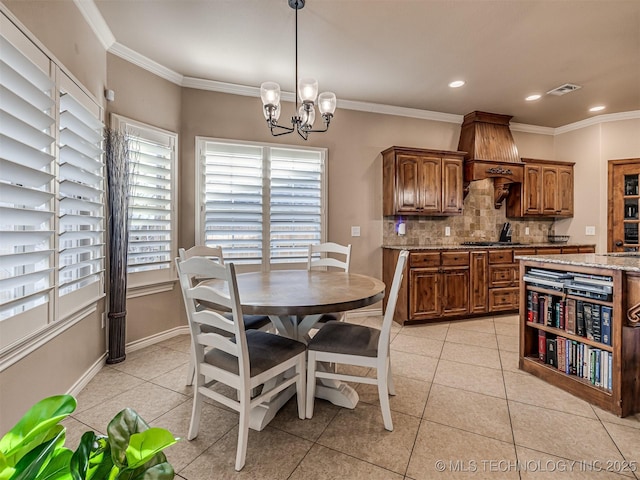 tiled dining space with ornamental molding and a chandelier