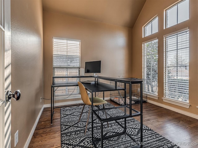 home office with vaulted ceiling and wood-type flooring