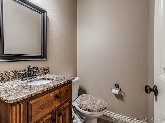 bathroom with toilet and vanity