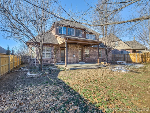 rear view of property with a yard and a patio