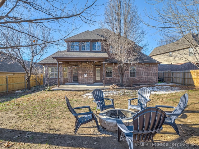 rear view of property with an outdoor fire pit and a patio