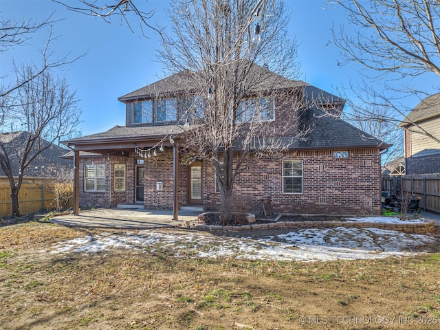 back of house with a yard and a patio