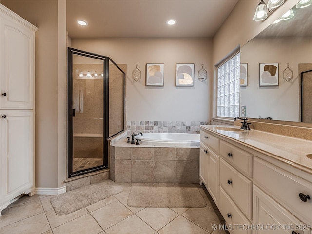 bathroom featuring vanity, tile patterned flooring, and shower with separate bathtub