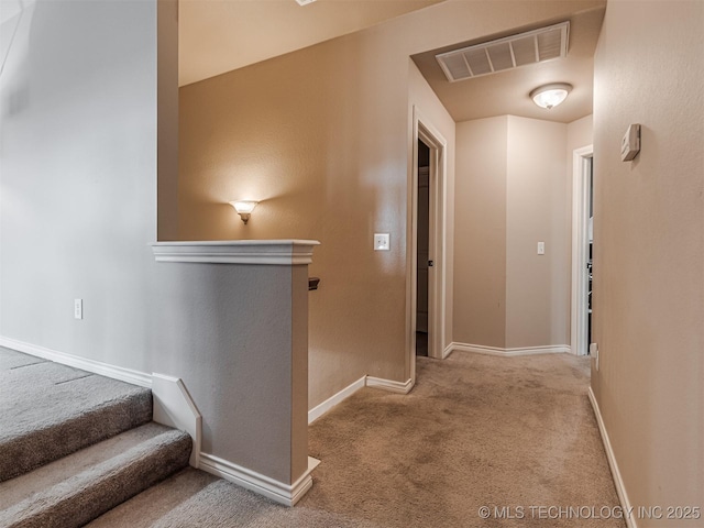 hallway featuring light colored carpet