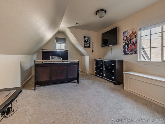 bedroom with lofted ceiling and light carpet