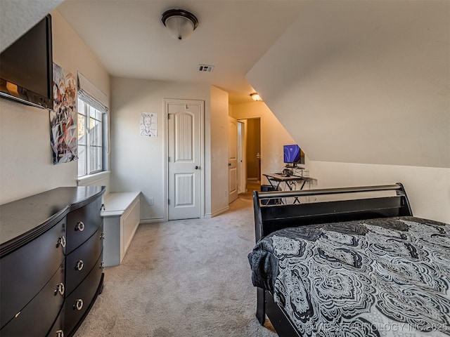 bedroom featuring light carpet and lofted ceiling