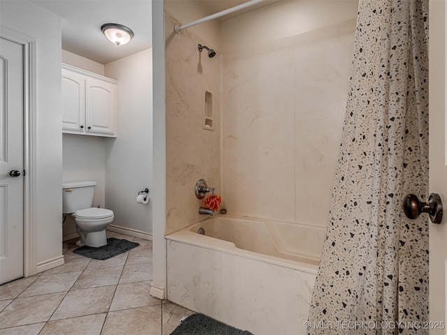 bathroom featuring tile patterned flooring, toilet, and bathing tub / shower combination