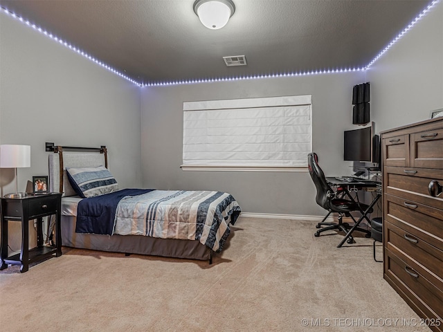 carpeted bedroom with a textured ceiling