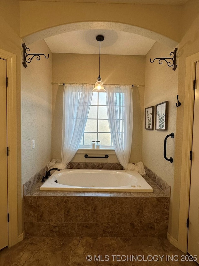 bathroom featuring tiled bath