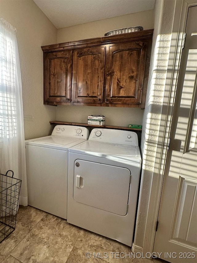 washroom with cabinets and independent washer and dryer