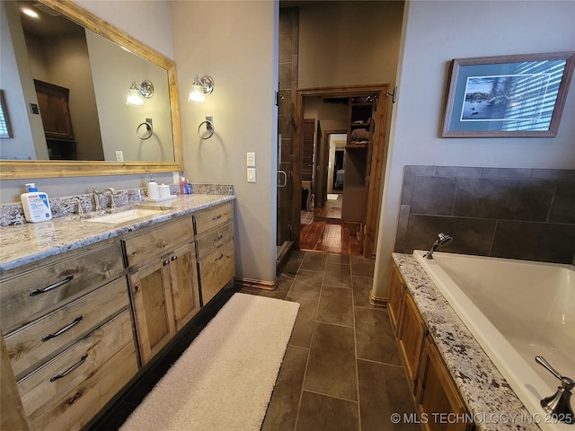 bathroom featuring vanity, tile patterned flooring, and shower with separate bathtub