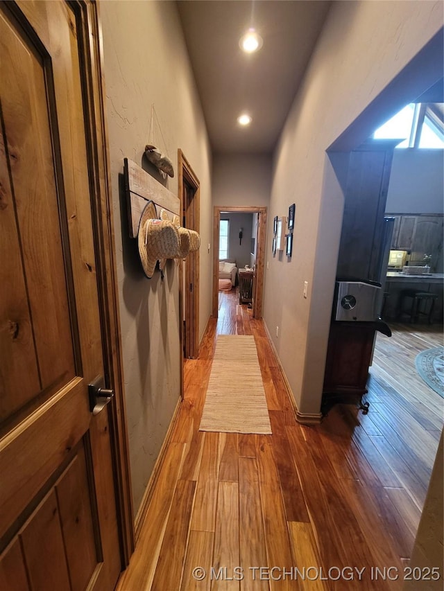 corridor with wood-type flooring