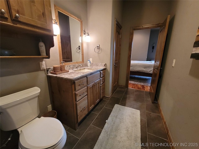 bathroom featuring tile patterned floors, vanity, and toilet