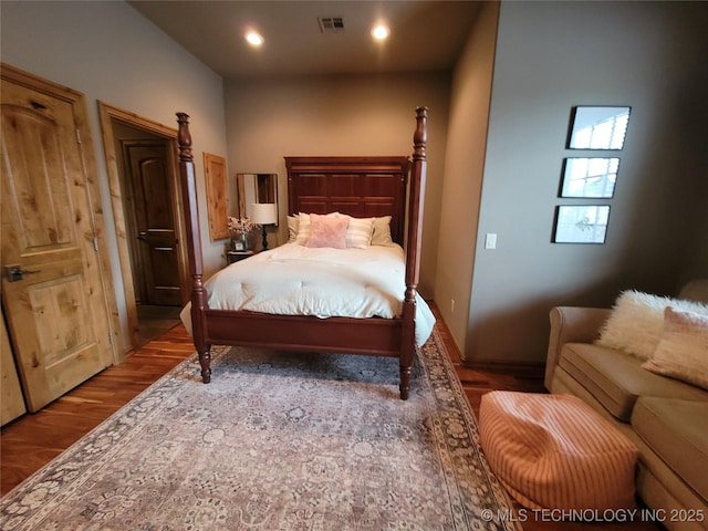 bedroom with hardwood / wood-style floors