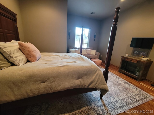 bedroom with hardwood / wood-style floors