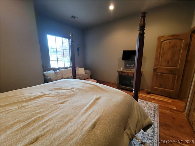 bedroom with hardwood / wood-style flooring