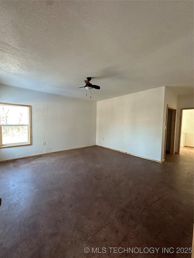 empty room featuring ceiling fan and a textured ceiling