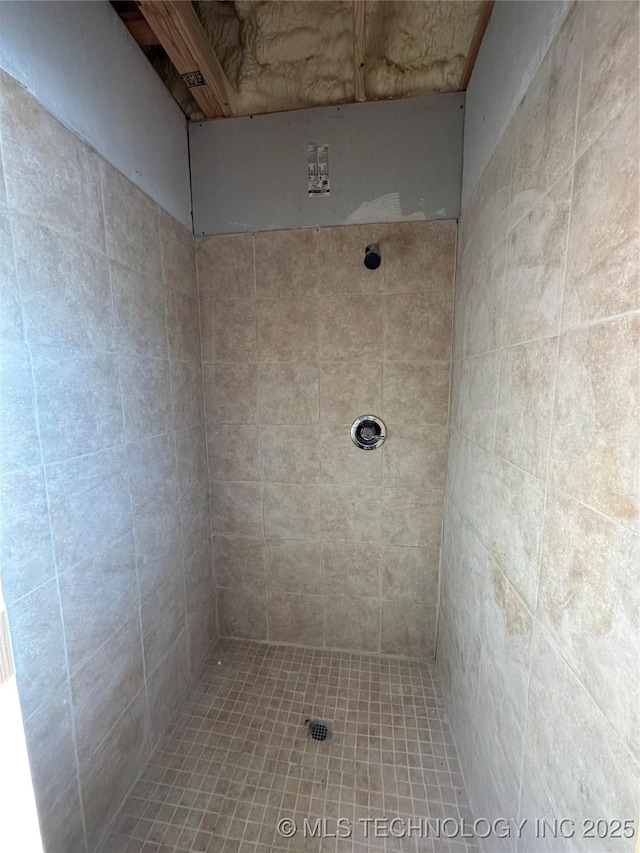 bathroom with tiled shower