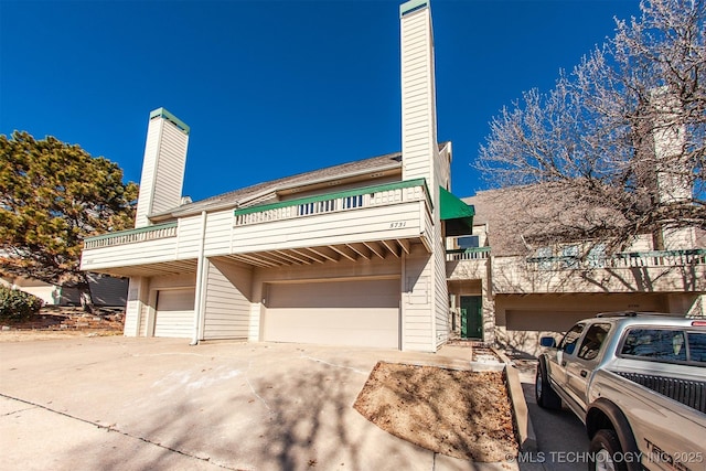 view of front facade featuring a balcony and a garage