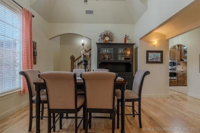 dining room featuring light hardwood / wood-style flooring and lofted ceiling