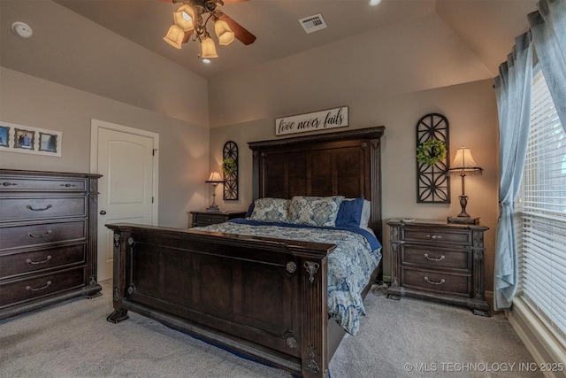 bedroom featuring ceiling fan, light carpet, and vaulted ceiling