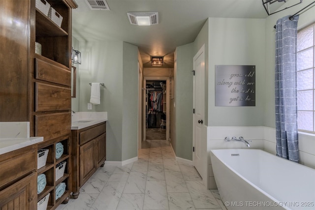 bathroom with a tub to relax in and vanity