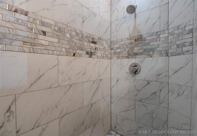 bathroom with tiled shower