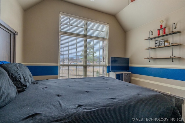 unfurnished bedroom with multiple windows and vaulted ceiling