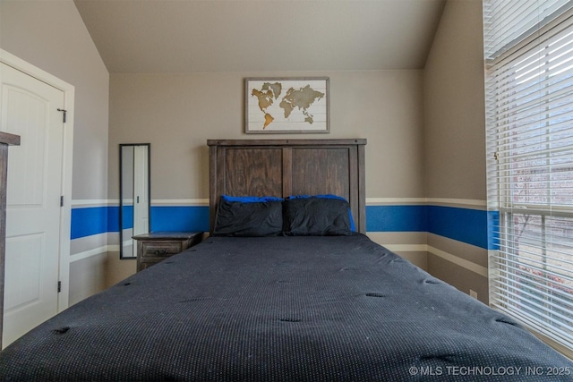 unfurnished bedroom with vaulted ceiling