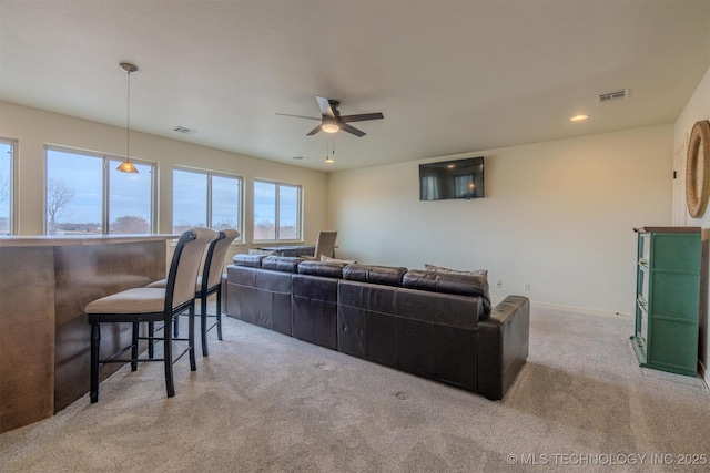 carpeted living room featuring ceiling fan