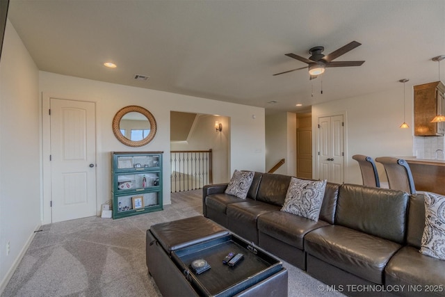 living room with ceiling fan and light colored carpet