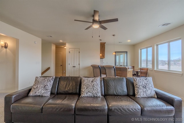 carpeted living room featuring ceiling fan