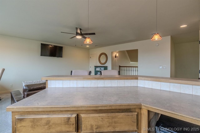 kitchen with decorative light fixtures and carpet