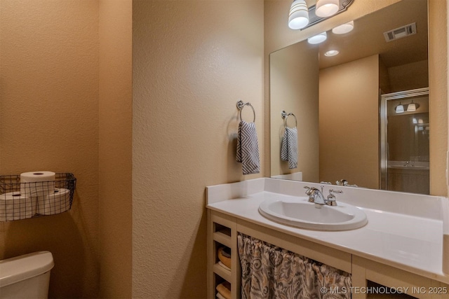 bathroom with toilet and vanity