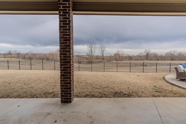 view of yard featuring a rural view and a patio