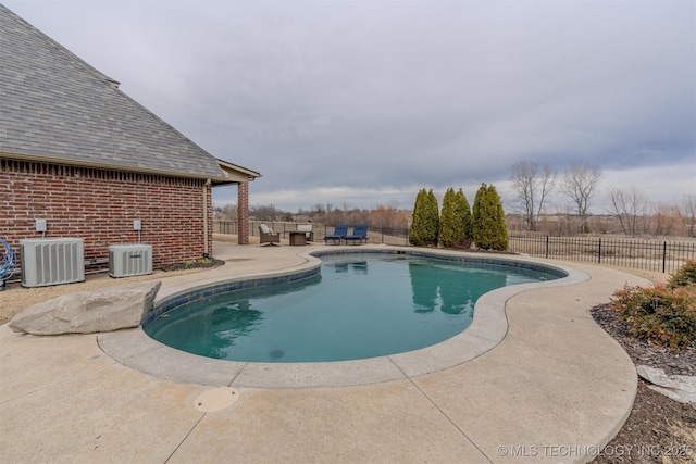 view of pool with central AC unit and a patio area