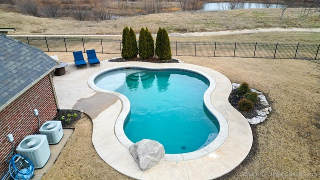 view of swimming pool featuring a patio area and a yard